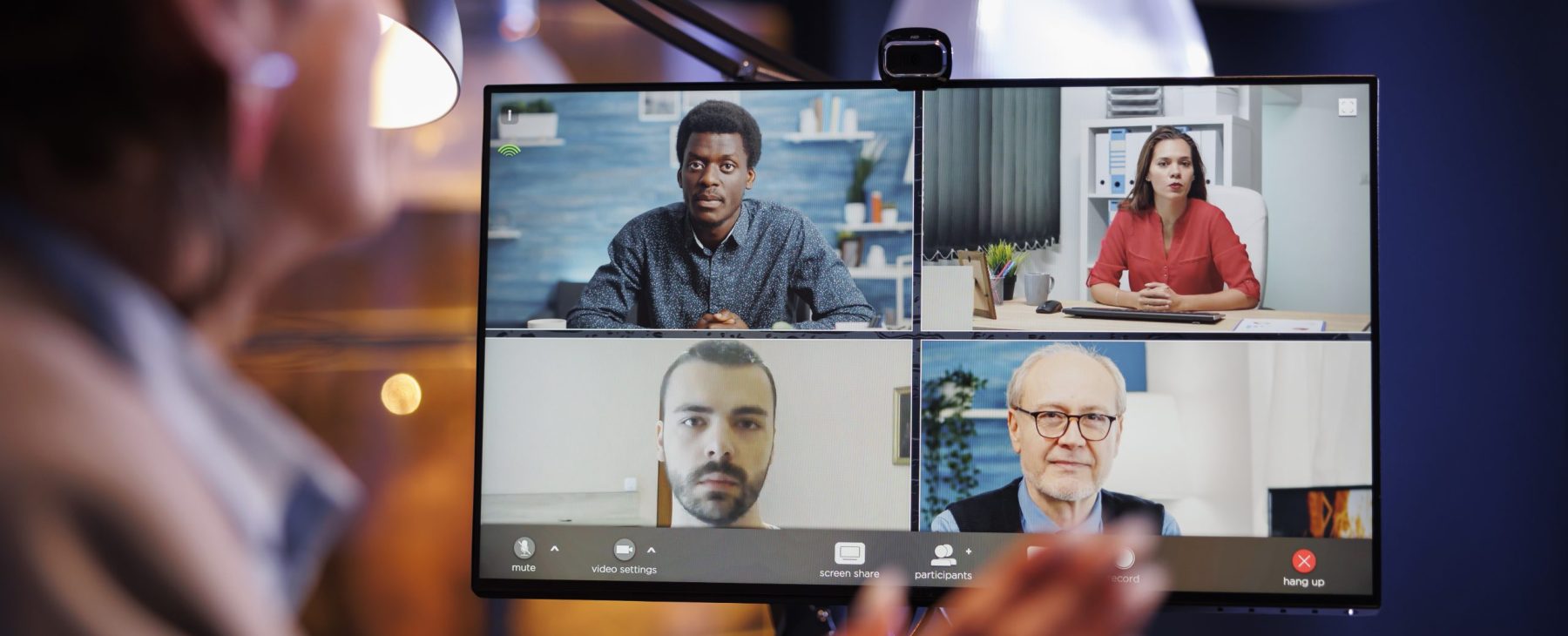 Manager greeting remote colleagues during videocall meeting conference, planning company startegy. Business coworkers working late at night at company investment plan to help increase profit